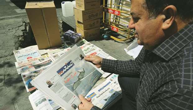 A man checks the front page of a newspaper featuring the recent events, in Tehran, yesterday.