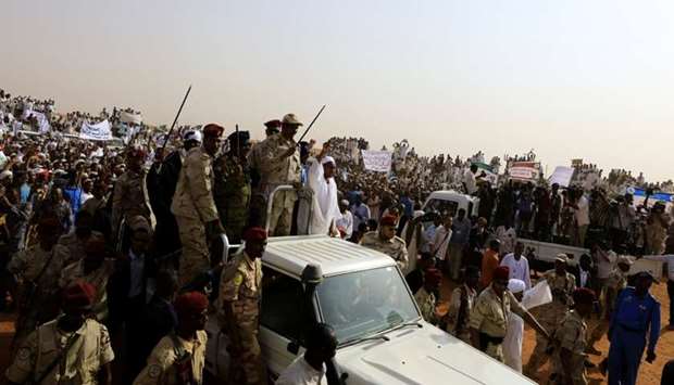 Lieutenant General Mohamed Hamdan Dagalo, deputy head of the military council and head of paramilitary Rapid Support Forces (RSF), greets his supporters as he arrives at a meeting in Aprag village, 60 kilometers away from Khartoum, Sudan