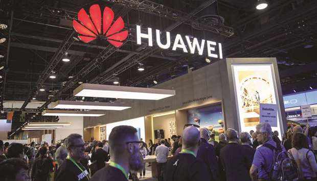 Attendees walk past the Huawei Technologies booth at the 2019 Consumer Electronics Show (CES) in Las Vegas, Nevada, on January 9.
