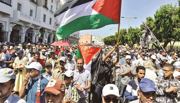 Protesters march with Palestinian flags during a demonstration in the Moroccan capital Rabat, yesterday, against the US-led economic conference in Bahrain.