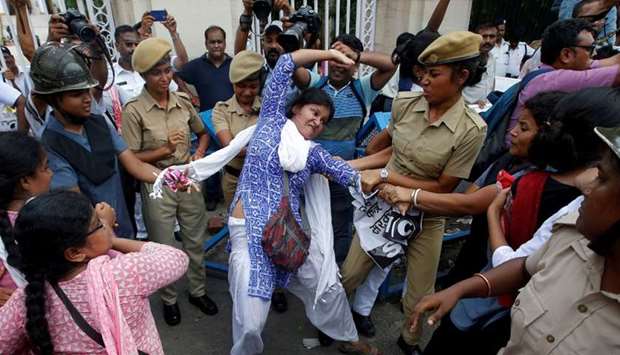 Police detain a demonstrator during a protest against the deaths of children who have died this month in the eastern Indian state of Bihar, from encephalitis, commonly known as brain fever, in Kolkata, India