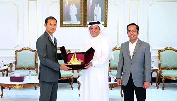 Abu Bakar receiving a token of recognition from al-Obaidli after a meeting held at Qatar Chamber's headquarters. Looking on is Salleh.