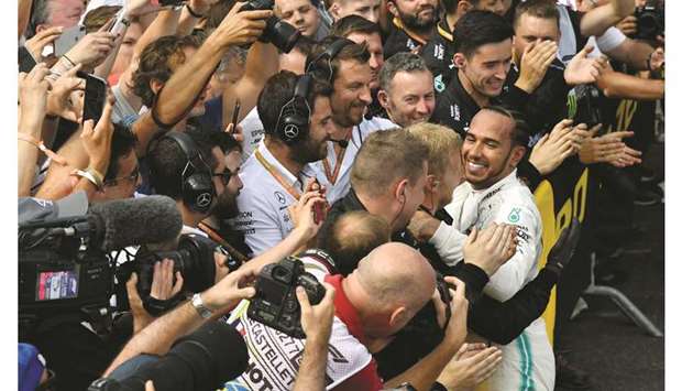 Mercedesu2019 British driver Lewis Hamilton (R) is congratulated by teammates after the Formula One Grand Prix de France in Le Castellet, southern France, on June 23.
