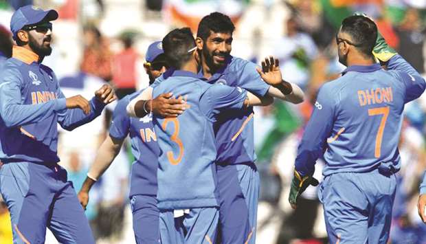 Indiau2019s Jasprit Bumrah (centre) celebrates with teammates after the dismissal of Afghanistanu2019s Hashmatullah Shahidi (not pictured) during the 2019 Cricket World Cup match at the Rose Bowl in Southampton, United Kingdom, on Saturday. (AFP)