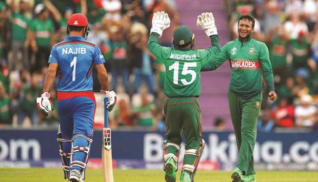 Bangladeshu2019s Shakib Al Hasan (right) celebrates taking the wicket of Afghanistanu2019s Najibullah Zadran (left) with teammate Mushfiqur Rahim during the 2019 ICC Cricket World Cup match in Southampton, United Kingdom, yesterday. (Reuters)