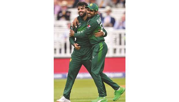 Pakistanu2019s Shadab Khan (left) celebrates with teammate Babar Azam after the dismissal of South Africau2019s Aiden Markram (not pictured) during the 2019 Cricket World Cup match in London on Sunday. (AFP)