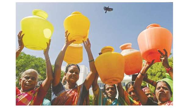 Indian women with empty plastic pots protest as they demand drinking water in Chennai on June 22. Angry residents fight in queues at water taps, lakes have been turned into barren moonscapes and restaurants are cutting back on meals as the worst drought in living memory grips Indiau2019s Chennai.