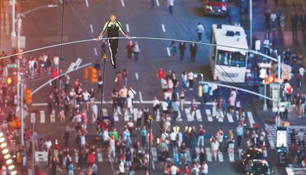 Aerialist Nik Wallenda walks the highwire over Times Square in New York on Sunday.