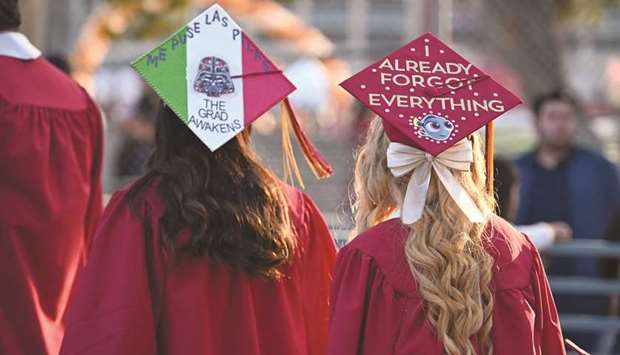 Graduating students in decorated academic caps attend Pasadena City Collegeu2019s graduation ceremony on June 14, 2019.