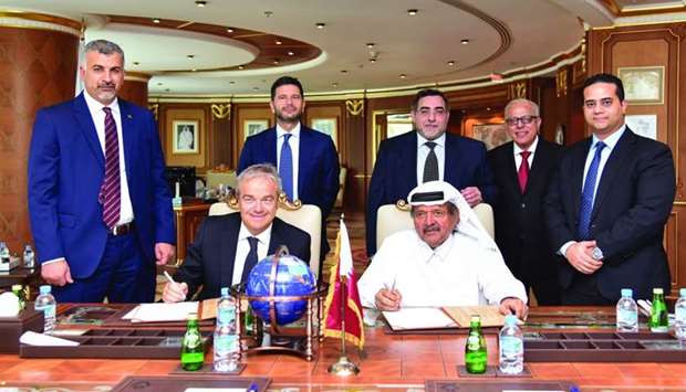 Sheikh Faisal and Rossi sign the agreement in the presence of Salzano and senior Aamal and GPI Group executives in Doha.