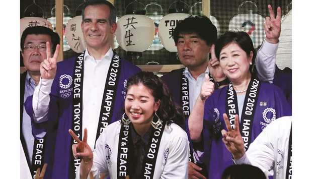 Tokyo Governor Yuriko Koike and Eric Garcetti, Mayor of Los Angeles, pose with other attendants during a countdown event to mark the two years until the opening of the 2020 Olympics in Tokyo yesterday.