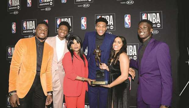 Milwaukee Bucks forward Giannis Antetokounmpo (third right) poses with his family members after winning the Most Valuable Player award at the 2019 NBA Awards show  in Los Angeles on Monday night. (USA TODAY Sports)