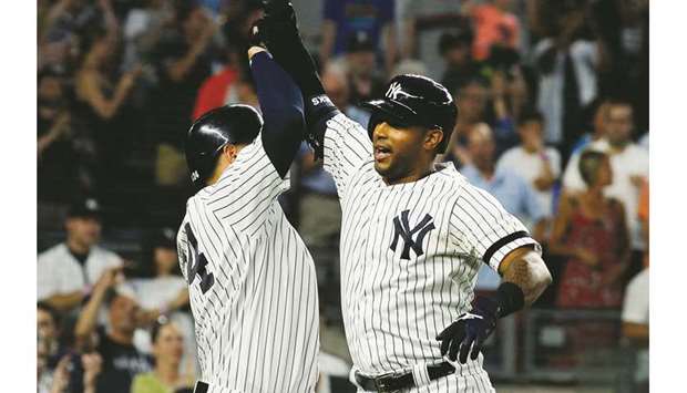 New York Yankees center fielder Aaron Hicks (right) celebrates with catcher Gary Sanchez after hitting a three-run home run against the Toronto Blue Jays during the MLB match at Yankee Stadium in New York. (USA TODAY Sports)