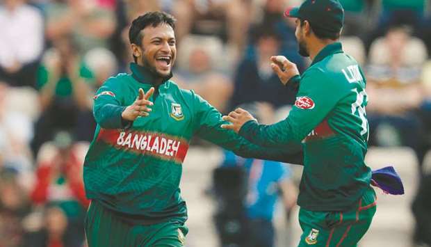 Bangladeshu2019s Shakib Al Hasan (left) celebrates after the dismissal of Afghanistanu2019s captain Gulbadin Naib (not pictured) during the 2019 ICC Cricket World Cup match at the Rose Bowl in Southampton, United Kingdom, on Monday. (AFP)