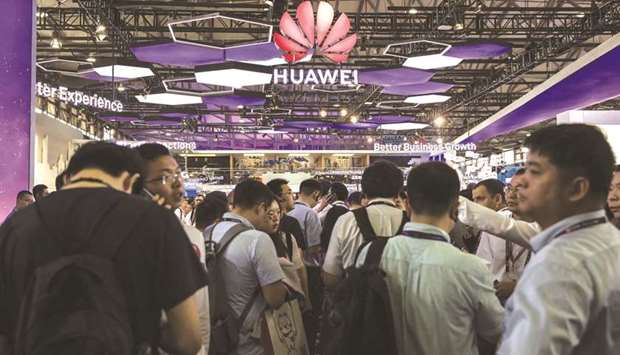 Attendees stand at the Huawei Technologies booth at the Mobile World Congress Shanghai in China (file).
