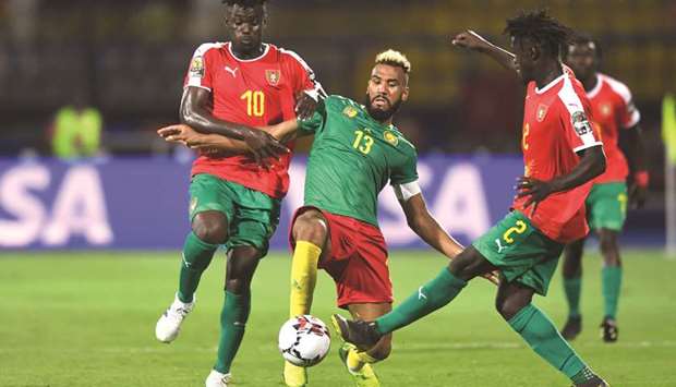 Cameroonu2019s Eric Maxim Choupo-Moting (centre) is marked by Guinea-Bissauu2019s Pele (left) and Eliseu Nadjack Soares during the Africa Cup of Nations in Ismailia, Egypt. (AFP)