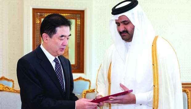 His Highness the Deputy Amir confers the Decoration of Al Wajba on Li Chen, the outgoing Ambassador of China, 