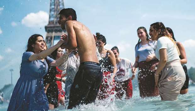 People cool themselves down in the fountain of the Trocadero esplanade in Paris yesterday.