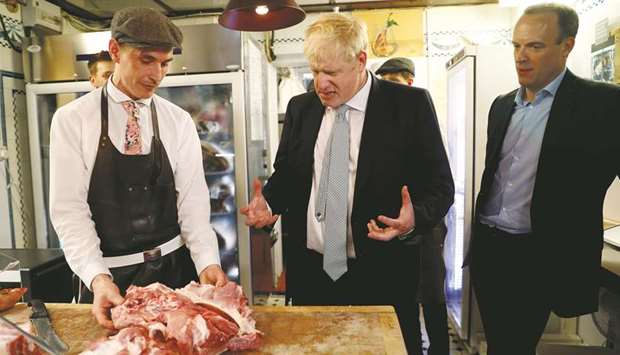 Boris Johnson and former Brexit minister Dominic Raab visit a butcheru2019s shop in Oxshott, Surrey.