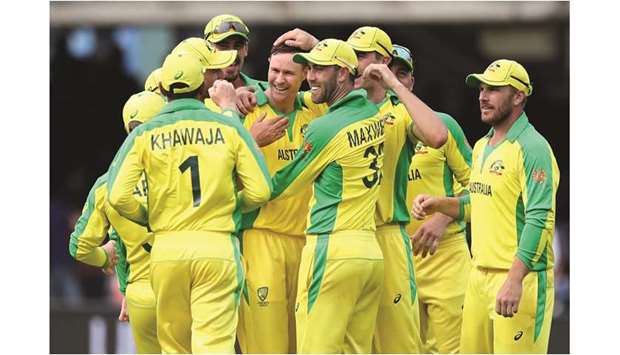 Australiau2019s Jason Behrendorff (centre) celebrates with teammates after taking the wicket of Englandu2019s Jofra Archer (not pictured) during the ICC Cricket World Cup match at Lordu2019s Cricket Ground in London yesterday. (Reuters)