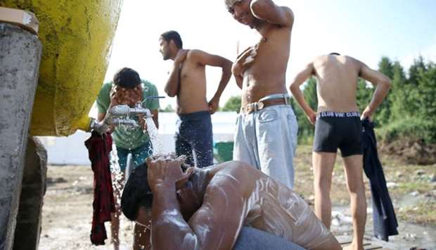 Migrants take a shower in camp Vucjak in Bihac, Bosnia and Herzegovina