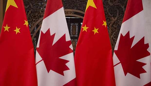 In this file photo taken on December 5, 2017 shows Canadian and Chinese flags taken prior to a meeting with Canada's Prime Minister Justin Trudeau and China's President Xi Jinping at the Diaoyutai State Guesthouse in Beijing