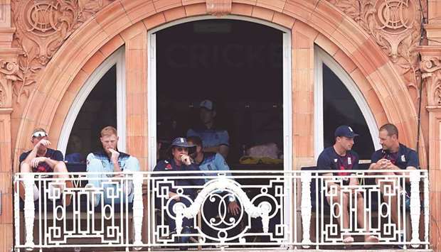 Englandu2019s Ben Stokes (second from left) watches the action from the balcony during the ICC Cricket World Cup match against Australia at Lordu2019s Cricket Ground in London on Tuesday. (Reuters)