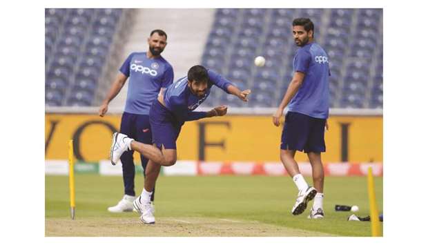 Indiau2019s Jasprit Bumrah (centre) bowls during a training session as teammates Bhuvneshwar Kumar (right) and Mohamed Shami look on at Old Trafford in Manchester, United Kingdom, yesterday. (AFP)