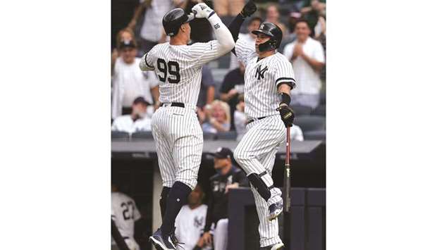 New York Yankees right fielder Aaron Judge (right) celebrates his solo home run against the Toronto Blue Jays with catcher Gary Sanchez (24) during the MLB match at the Yankee Stadium on Tuesday night. (USA TODAY Sports)