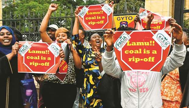 Kenya environmental activists celebrate outside the Supreme Court in Nairobi after the Kenya National Environmental Tribunal blocked the construction of a coal-fired power station.