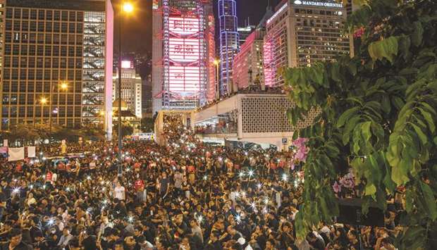 Demonstrators wave their smartphones at a rally ahead of the G20 summit, urging international community to back their demands for the government to withdraw a the extradition bill in Hong Kong.