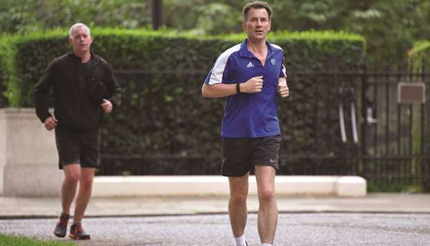 Conservative Party leadership candidate Jeremy Hunt returns from his morning run in London yesterday.