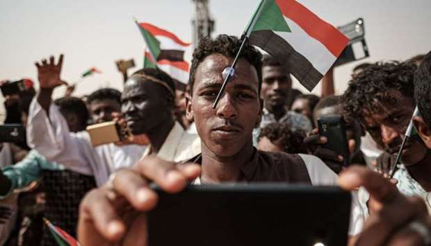 A man poses for a ,selfie, photo with a cell phone as he awaits the arrival of the deputy head of Sudan's ruling Transitional Military Council (TMC) and commander of the Rapid Support Forces (RSF) paramilitaries, during a rally in the village of Abraq, about 60 kilometers northwest of Khartoum, on June 22, 2019