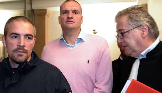 n this file photo taken on May 30, 2013 Marc Bertoldi (C), suspected of having participated in the theft of diamonds at the Brussels airport, arrives in the courtroom at the Metz courthouse.