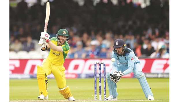 Australiau2019s David Warner (left) plays a shot during the 2019 ICC Cricket World Cup match against England at the Lordu2019s Cricket Ground in London on Tuesday. (Reuters)