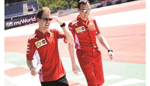 Ferrariu2019s German driver Sebastian Vettel (L) during a track walk ahead of the Austrian Formula One Grand Prix in Spielberg, Austria, yesterday.