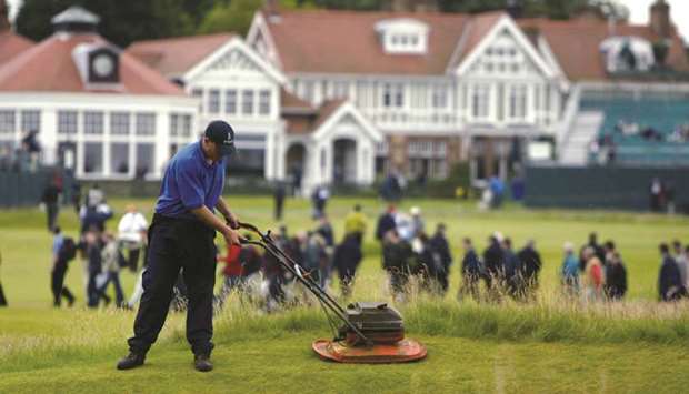 Greenkeepers prepare the Muirfield course for the 131st British Open Championship in this July 17, 2002 file photo.