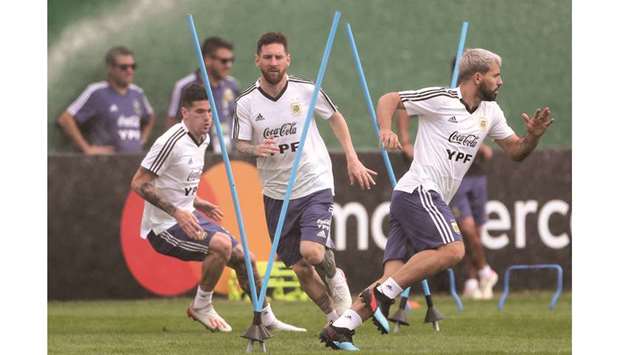 Argentinau2019s Lionel Messi (centre) and Sergio Aguero train in Rio de Janeiro, Brazil, yesterday. (Reuters)