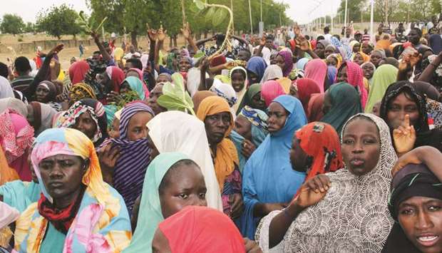 Internally displaced people affected by the Boko Haram militancy block a highway to protest against shortage of food in Maiduguri.