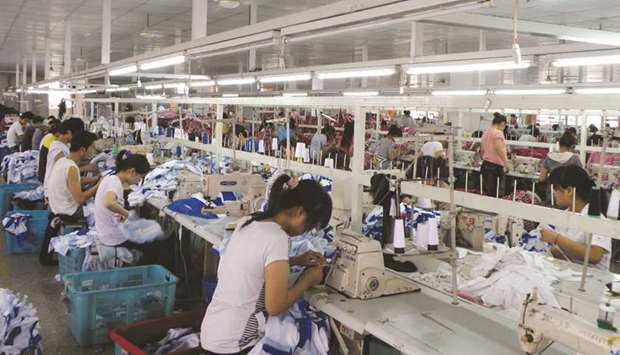 Employees work at a garment factory in Shanghai. Profits for Chinau2019s industrial companies rose 1.1% in May from a year earlier to 565.6bn yuan ($82.21bn), according to data released by the National Bureau of Statistics yesterday.