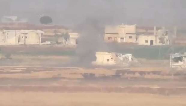 Smoke bellows after an airstrike in Hama province