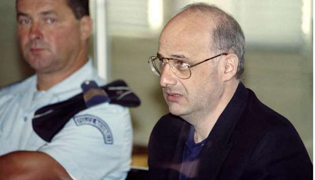 In this file photo taken on June 25, 1996 French citizen Jean-Claude Romand (R) arrives for the start of his trial at the courthouse of Bourg-en-Bresse.