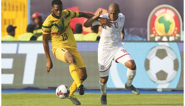 Tunisiau2019s Wahbi Khazri (right) and Maliu2019s Molla Wague tussle for the ball during the Africa Cup of Nations match in Suez, Egypt. (Reuters)