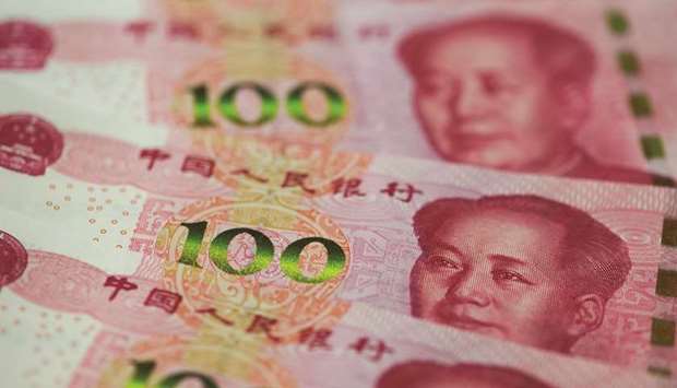 Yuan banknotes are arranged for a photograph in Seoul. The yuan rose to 6.8674 per dollar in Shanghai yesterday.