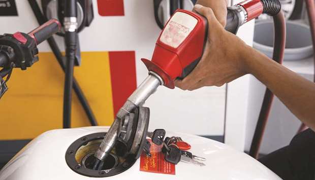 A customer refuels a motorcycle at a Royal Dutch Shell gas station in Johor Bahru, Malaysia. Shell has bought a total 15mn barrels of Middle East crude for loading in August through deals on pricing platforms Platts and RIM during this month, according to trade sources.
