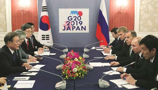 Russian President Vladimir Putin and South Koreau2019s President Moon Jae-in hold a bilateral meeting on the sidelines of the G20 summit in Osaka yesterday. Many leaders of the worldu2019s top 20 economies yesterday voiced concern over trade tensions and the risk they pose to global growth, but were at loggerheads on key issues such as World Trade Organisation reform, Japanese and Russian delegates said.