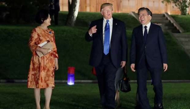 US President Donald Trump and South Korean President Moon Jae-in leave after a banquet at the Presidential Blue House in Seoul, South Korea