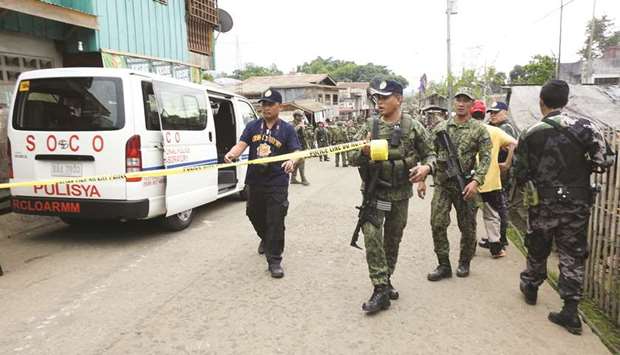 Security forces and Scene of the Crime Operatives (SOCO) prepare the police line to cordon off the area for the investigation after a blast in the temporary Camp of 1st Brigade Combat Team (1BCT) in Barangay Kajatian, Indanan, Sulu.