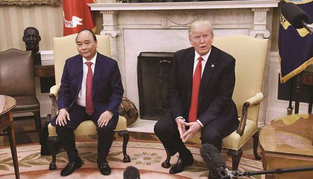 US President Donald Trump (right), speaks to members of the media as Nguyen Xuan Phuc, Vietnamu2019s Prime Minister, looks on during a meeting in the Oval Office of the White House in Washington (file). Vietnam ran a trade surplus of $17bn with the US in the first five months of this year, compared to last yearu2019s surplus of $12.9bn in the same period.
