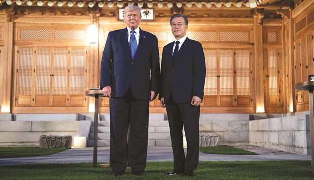 US President Donald Trump and South Koreau2019s President Moon Jae-in stand together before a working dinner at the tea house on the grounds of the presidential Blue House in Seoul yesterday.